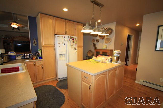 1629 P Road Loma, CO 81524 - Photo 8 of 18 a kitchen with a refrigerator a stove top oven a sink and dining table