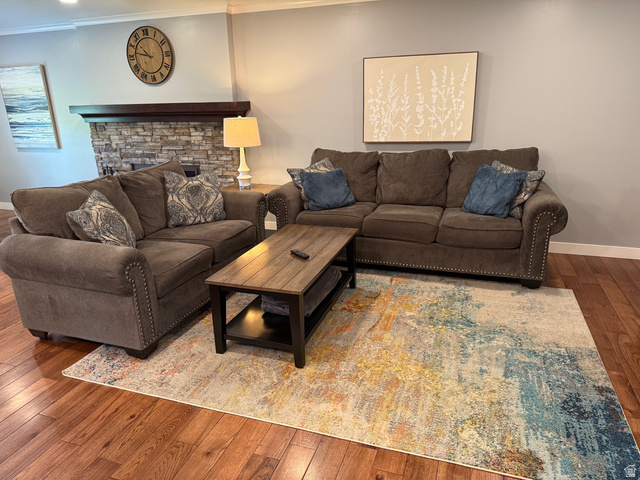 362 East 9150th Street South Sandy, UT 84070 - Photo 4 of 41 Living room featuring hardwood / wood-style floors, ornamental molding, and a fireplace