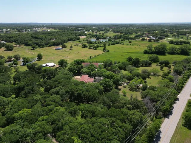 an aerial view of a houses with a yard