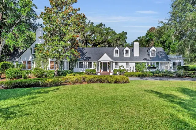 a front view of a house with garden and porch