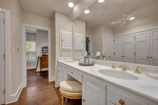 a bathroom with a tub a sink and a window