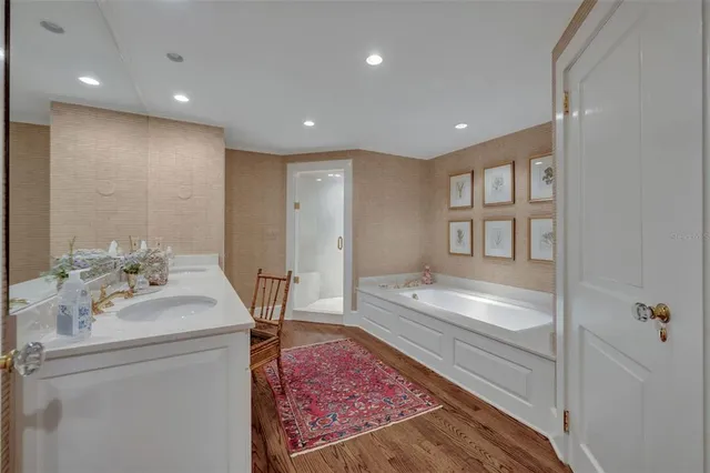 a large bathroom with a sink a vanity and a large mirror
