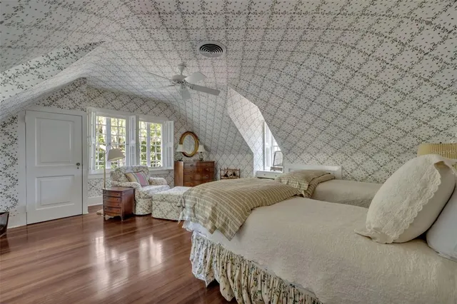 a spacious bedroom with a bed and a table