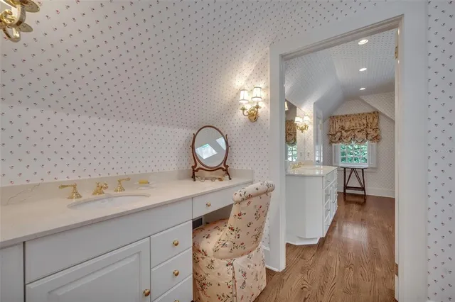 a spacious bathroom with a granite countertop tub a double vanity sink and a large mirror