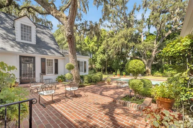 a view of a patio with couches table and chairs and potted plants