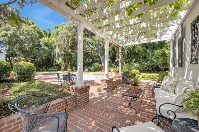 a view of a patio with table and chairs and potted plants