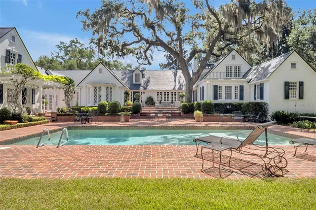 a front view of a house with a yard and potted plants