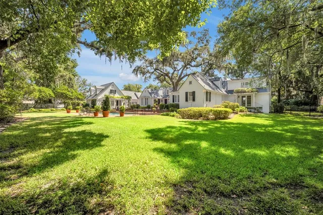 a view of swimming pool with outdoor seating and plants