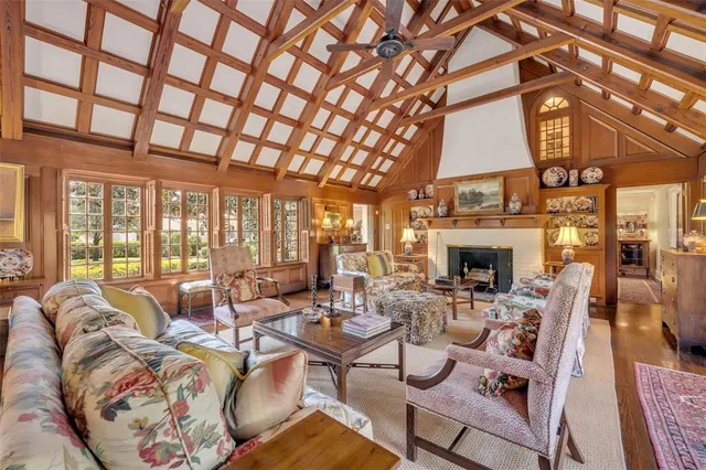 a living room with furniture a fireplace and a table
