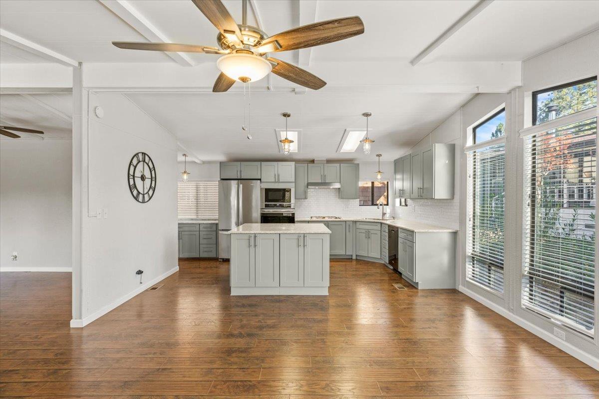 4420 Pleasant Valley Road, Unit 184 Diamond Springs, CA 95619 - Photo 11 of 28 a large kitchen with a center island stainless steel appliances and a window