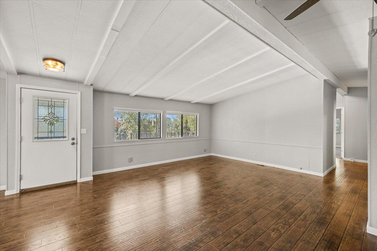 4420 Pleasant Valley Road, Unit 184 Diamond Springs, CA 95619 - Photo 16 of 28 an empty room with wooden floor and windows