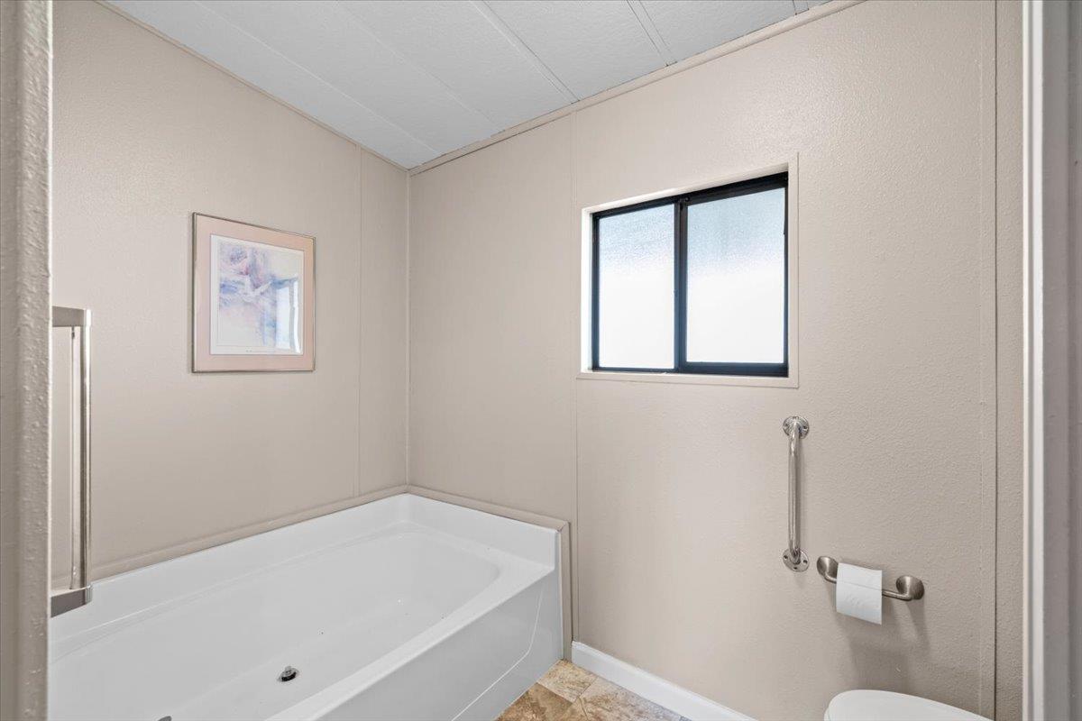 4420 Pleasant Valley Road, Unit 184 Diamond Springs, CA 95619 - Photo 23 of 28 a bathroom with a toilet and a shower