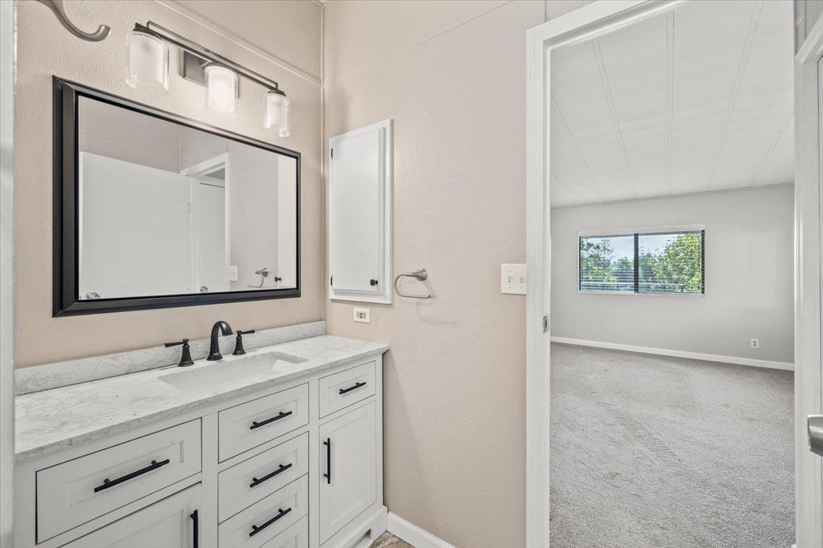 4420 Pleasant Valley Road, Unit 184 Diamond Springs, CA 95619 - Photo 24 of 28 a bathroom with a sink a vanity and a mirror