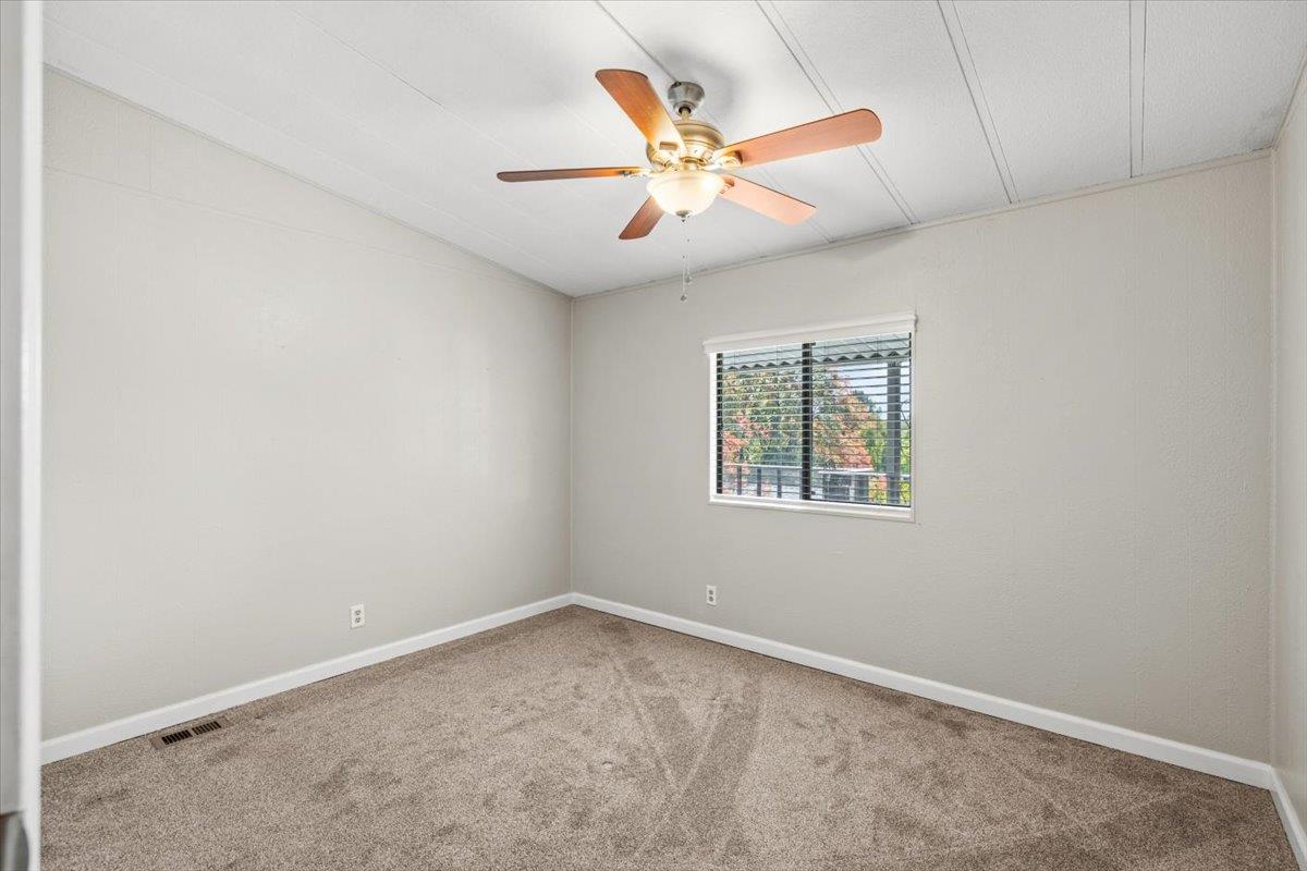 4420 Pleasant Valley Road, Unit 184 Diamond Springs, CA 95619 - Photo 25 of 28 an empty room with a window and a fan
