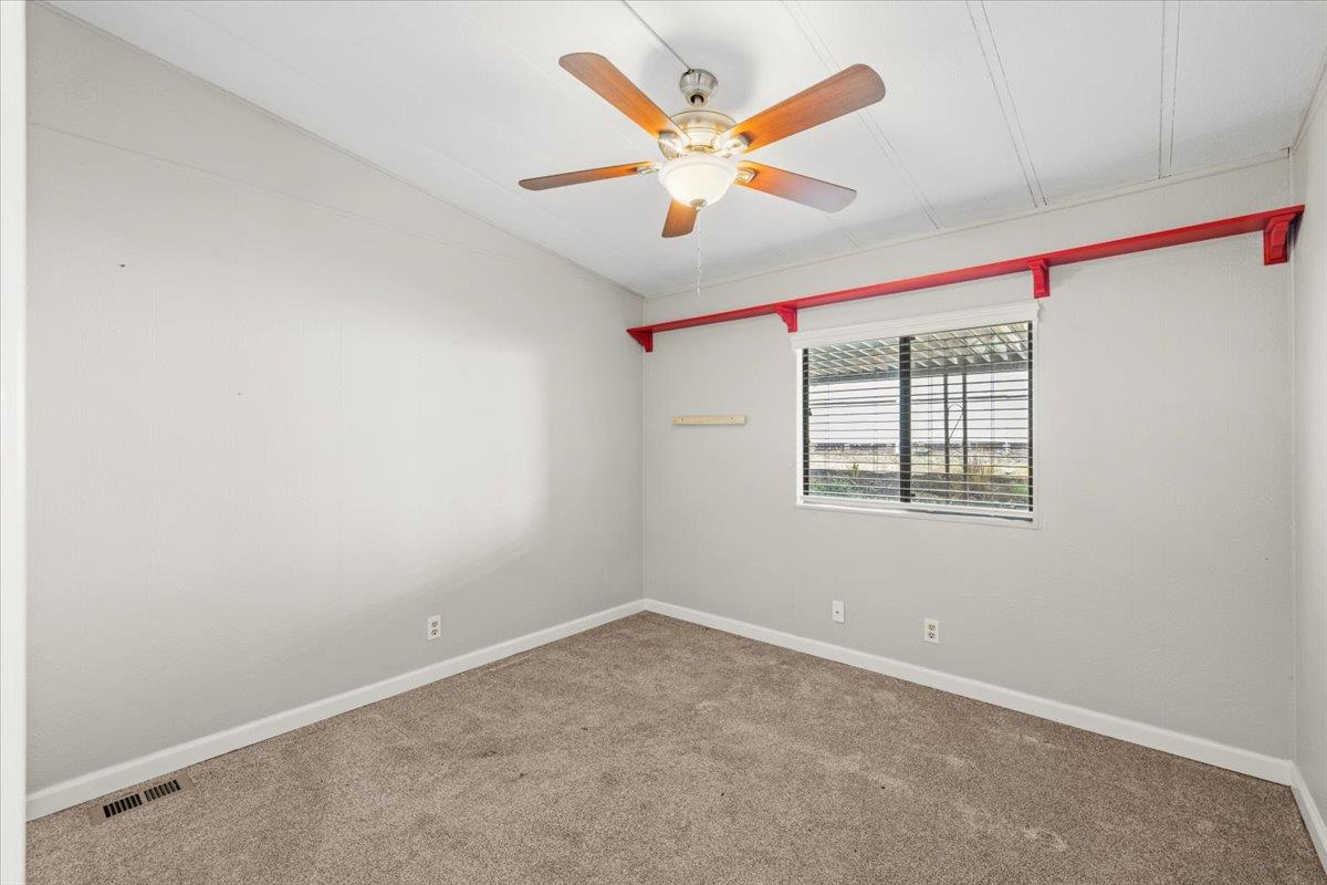 4420 Pleasant Valley Road, Unit 184 Diamond Springs, CA 95619 - Photo 27 of 28 an empty room with ceiling fan and window