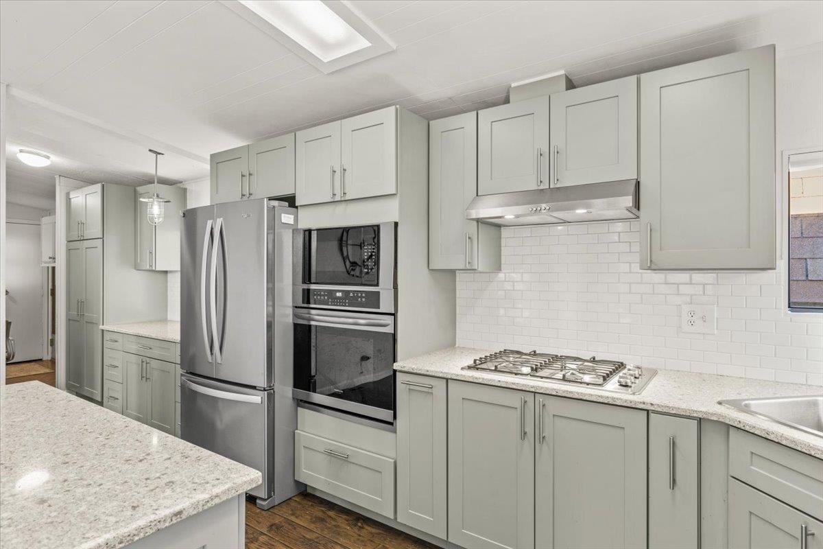 4420 Pleasant Valley Road, Unit 184 Diamond Springs, CA 95619 - Photo 7 of 28 a kitchen with stainless steel appliances granite countertop a refrigerator sink and stove