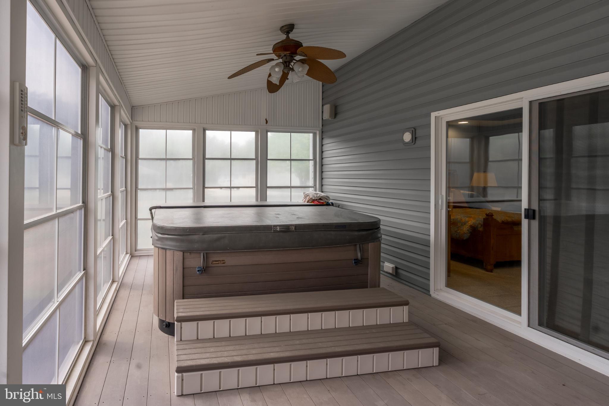 2435 Payne Road Pocomoke City, MD 21851 - Photo 41 of 75 Serene sunroom with a hot tub retreat.