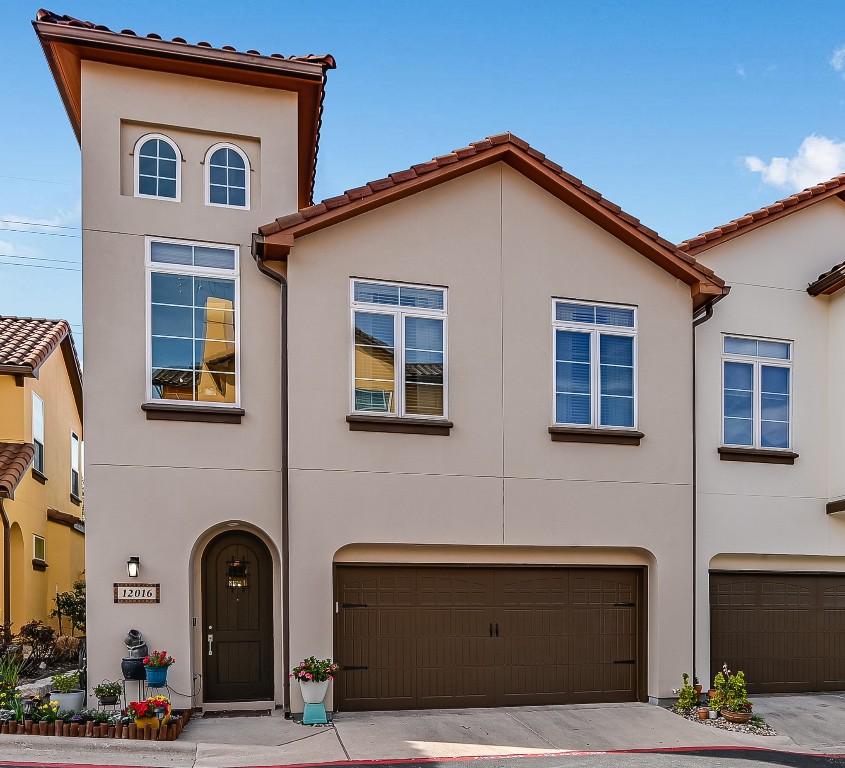a front view of a house with many windows