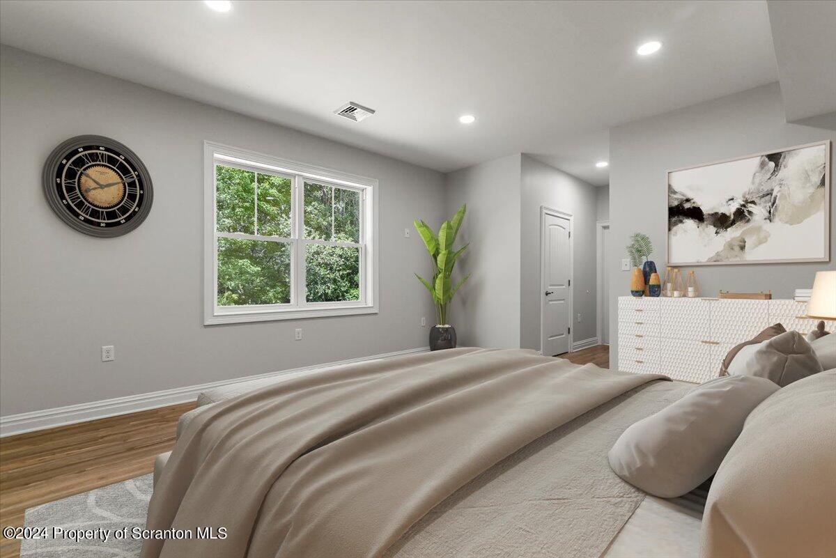 3 Dunbar Way Old Forge, PA 18518 - Photo 9 of 29 a bedroom with a large bed and a chandelier