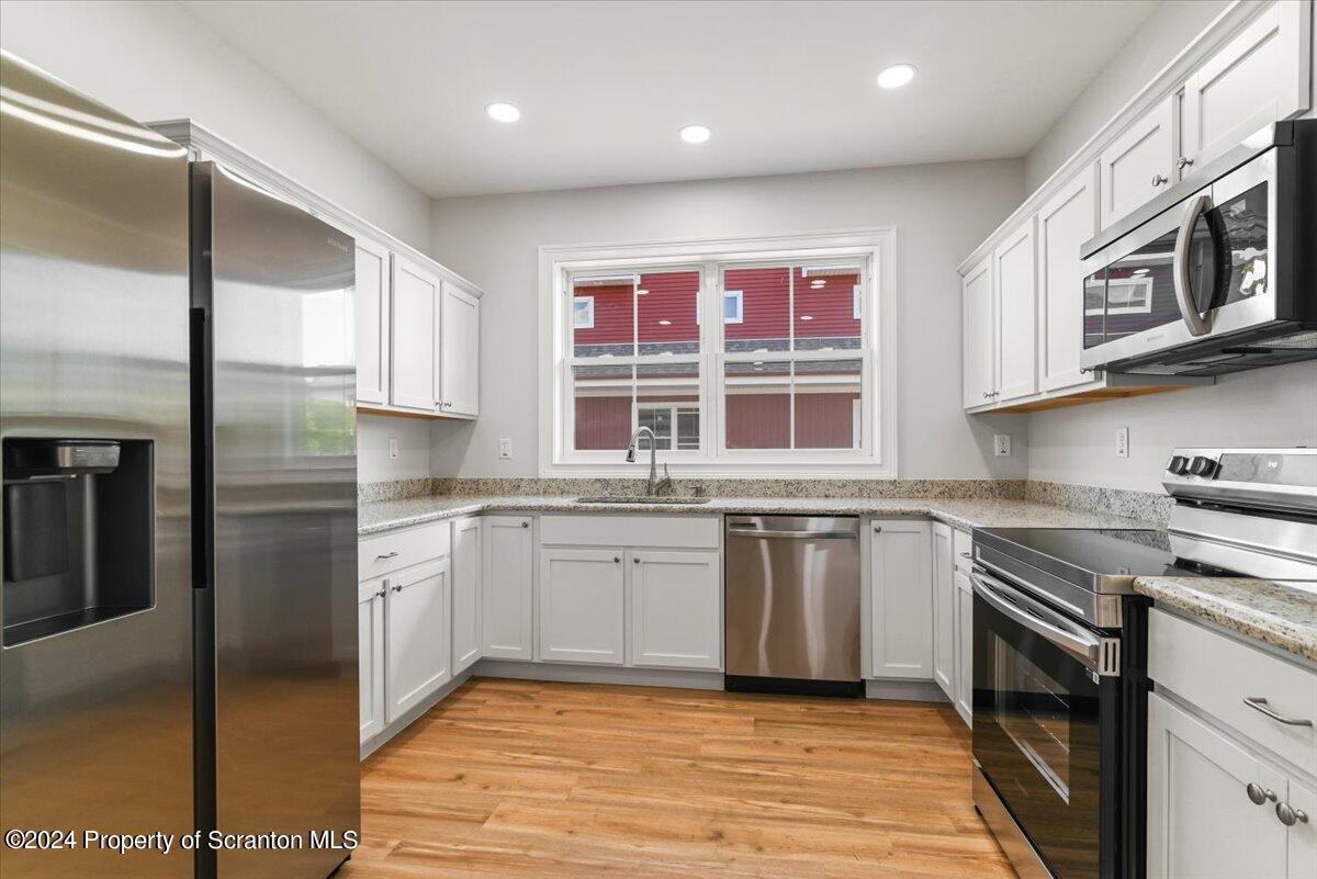 3 Dunbar Way Old Forge, PA 18518 - Photo 2 of 29 a kitchen with stainless steel appliances granite countertop a stove a sink and a refrigerator