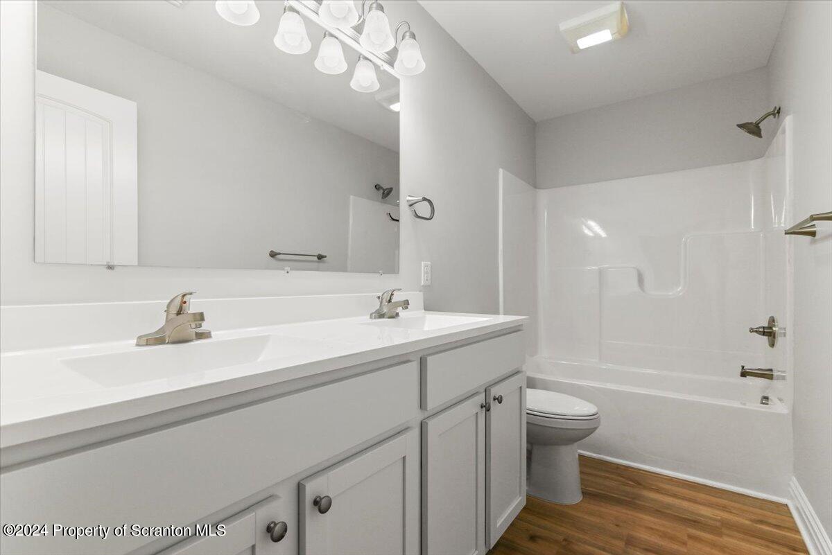 3 Dunbar Way Old Forge, PA 18518 - Photo 22 of 29 a bathroom with a sink a toilet a tub and shower