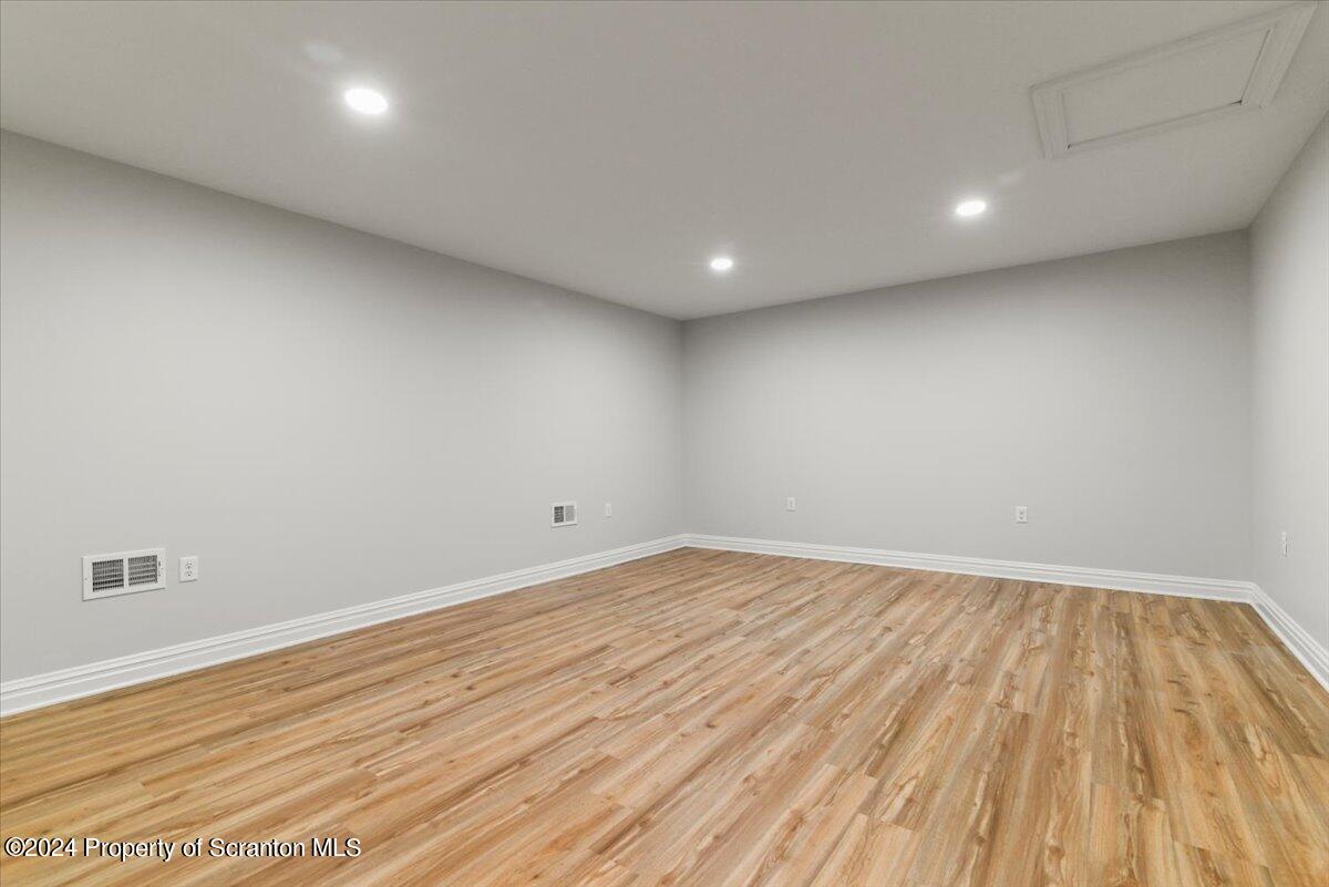 3 Dunbar Way Old Forge, PA 18518 - Photo 23 of 29 an empty room with wooden floor and windows