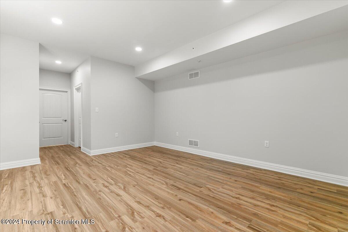 3 Dunbar Way Old Forge, PA 18518 - Photo 8 of 29 an empty room with wooden floor and windows