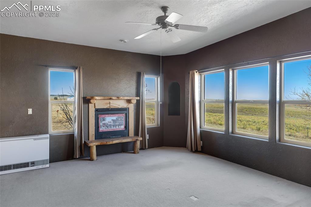 18450 Eurich Road Calhan, CO 80808 - Photo 14 of 48 a view of an empty room with a window and a fireplace