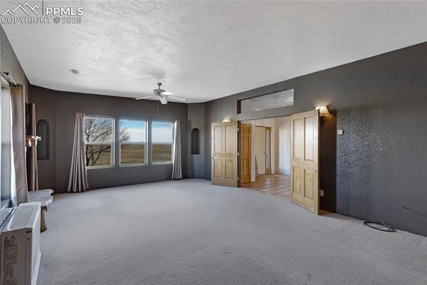 an empty room with windows and closet