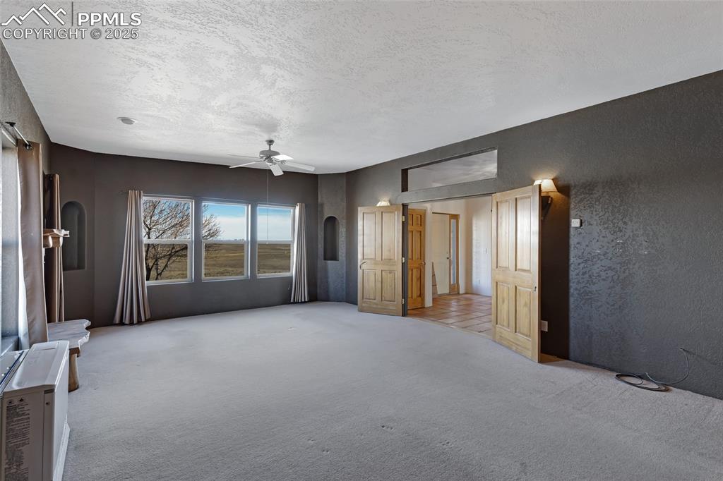 18450 Eurich Road Calhan, CO 80808 - Photo 16 of 48 an empty room with windows and closet