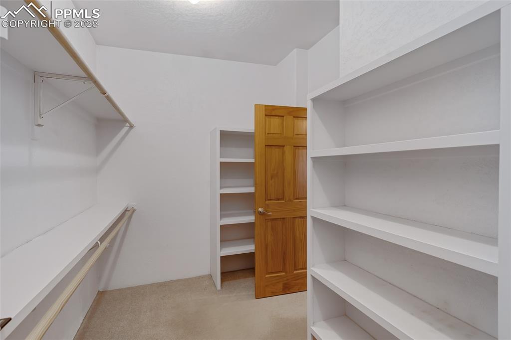 18450 Eurich Road Calhan, CO 80808 - Photo 17 of 48 a view of walk in closet with empty racks