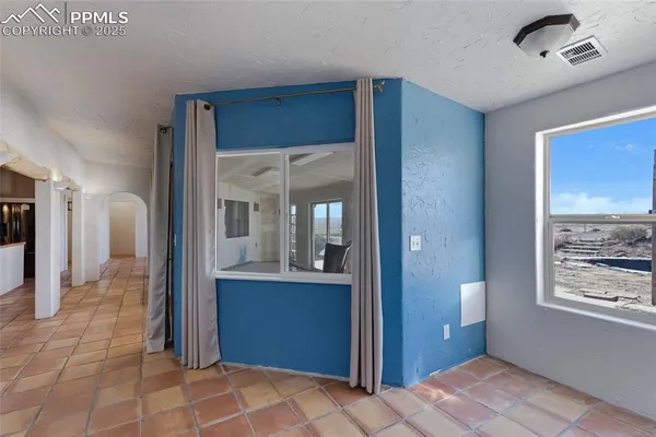 a view of hallway with a large mirror and a sink