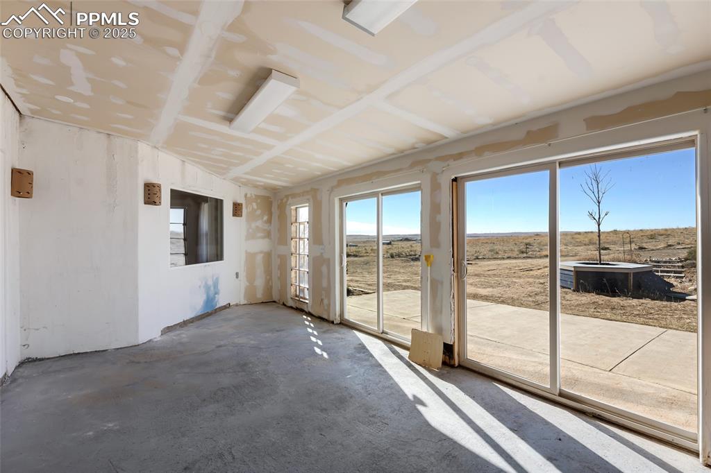 18450 Eurich Road Calhan, CO 80808 - Photo 21 of 48 a view of a livingroom with wooden floor and sliding glass door
