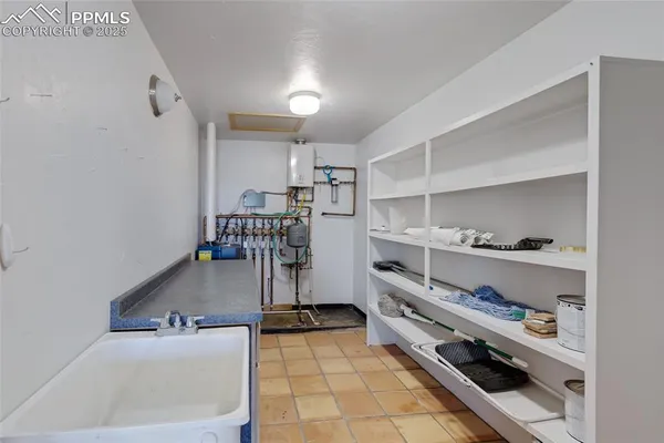 a kitchen with stainless steel appliances granite countertop a sink and a refrigerator