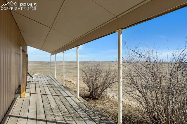 a view of a hallway with wooden floor and closet