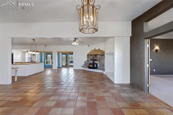 a view of a hallway with wooden floor and a kitchen