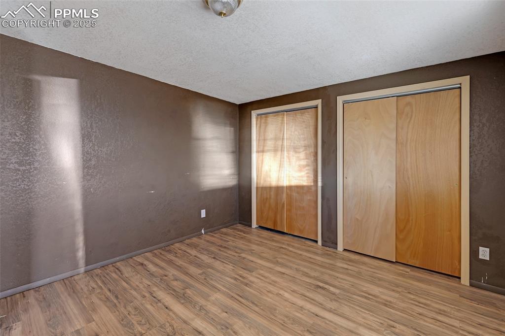 18450 Eurich Road Calhan, CO 80808 - Photo 42 of 48 a view of empty room with wooden floor and fan