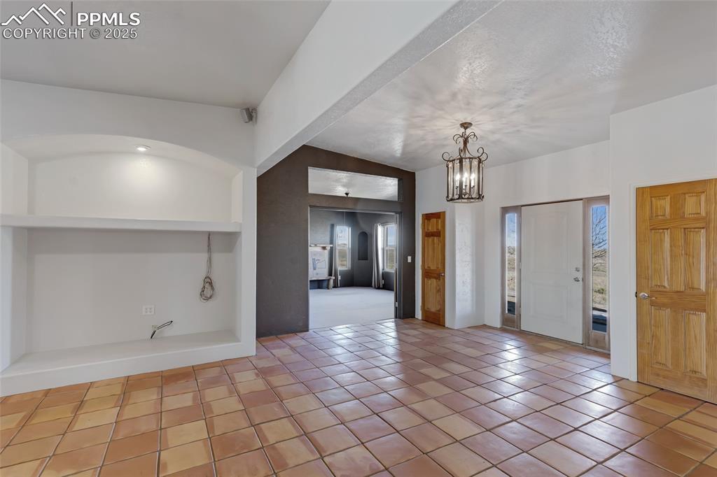 18450 Eurich Road Calhan, CO 80808 - Photo 5 of 48 a view of a hallway with wooden shelves