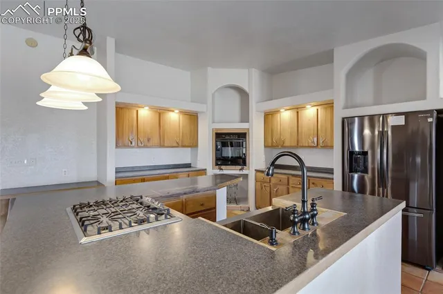 a kitchen with a sink a counter cabinets and appliances