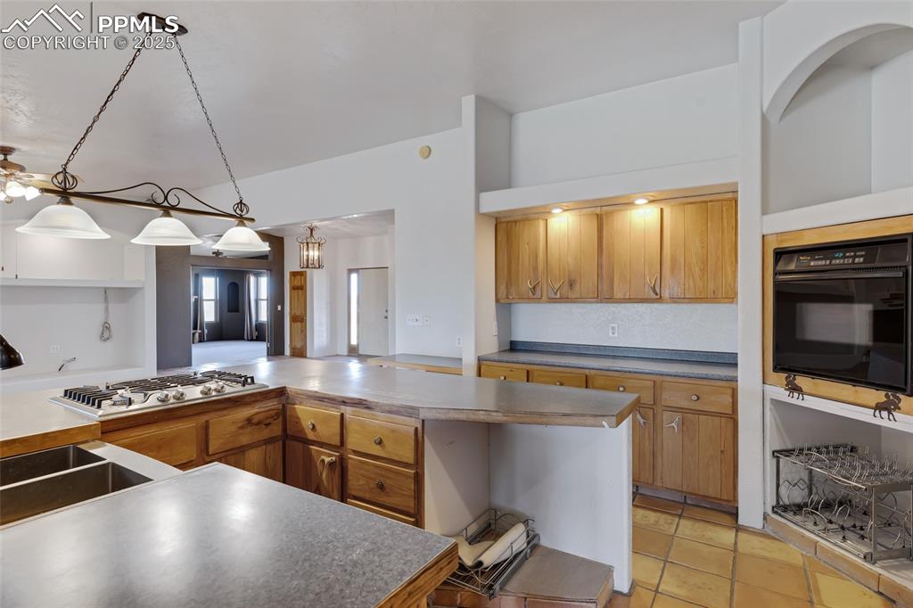 18450 Eurich Road Calhan, CO 80808 - Photo 10 of 48 a kitchen with stainless steel appliances kitchen island granite countertop a sink and cabinets