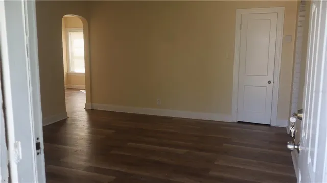a view of a room with wooden floor and a window