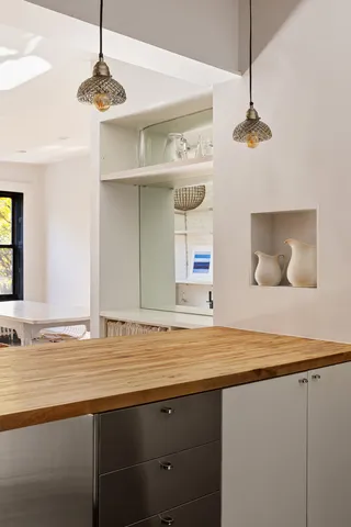 a view of a kitchen with a sink and chandelier