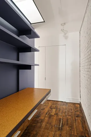 a view of a room with wooden floor