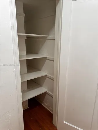 a view of walk in closet with empty racks