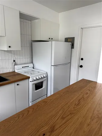 a kitchen with a stove a refrigerator and a sink