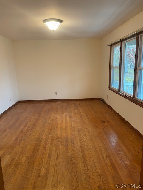 5600 Qualla Road Chesterfield, VA 23832 - Photo 2 of 6 a view of an empty room with wooden floor and a window