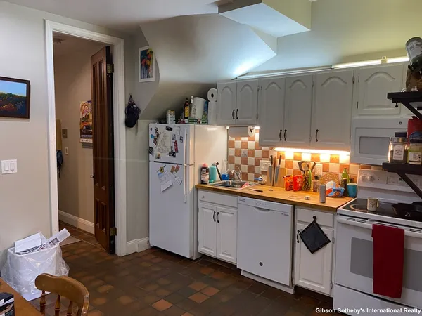 a kitchen with stainless steel appliances a refrigerator and a stove