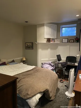 a bed sitting in a kitchen next to a window