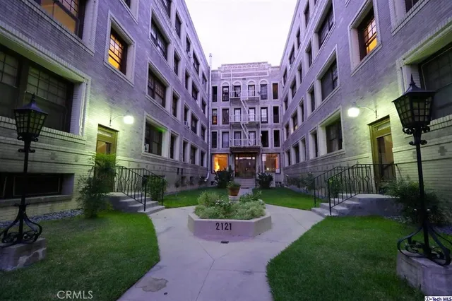 a view of a building with a yard