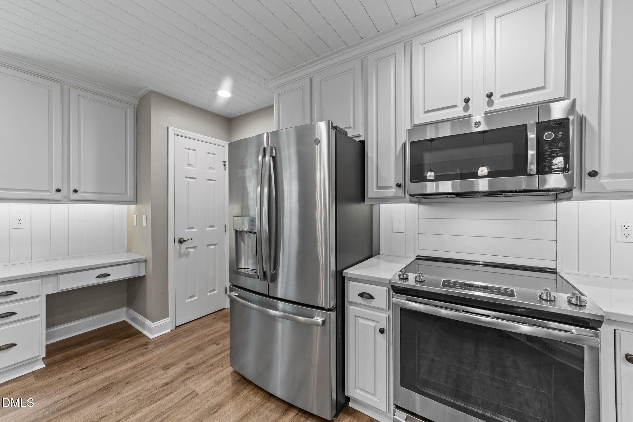 6820 Oviedo Drive Raleigh, NC 27603 - Photo 11 of 50 a kitchen with stainless steel appliances a stove a microwave and a refrigerator